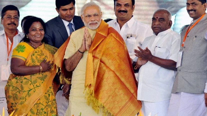 Prime Minister Narendra Modi is presented with a shawl by Tamil Nadu BJP chief Thamizhisai Soundararajan at a public meeting in Coimbatore Prime Minister Narendra Modi is presented with a shawl by Tamil Nadu BJP chief Thamizhisai Soundararajan at a public meeting in Coimbatore