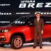A Maruti official poses with compact SUV Vitara Brezza at its launch at Auto Expo 2016 in Greater Noida (pic: Dalip Kumar)