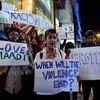 Students from different colleges hold placards and Candles during a protest against the attack on a Tanzanian girl by a mob in Bengaluru