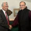 Union Finance Minister Arun Jaitley shakes hands with his counterpart from Nepal, Bishnu Prasad Poudel at a meeting in New Delhi