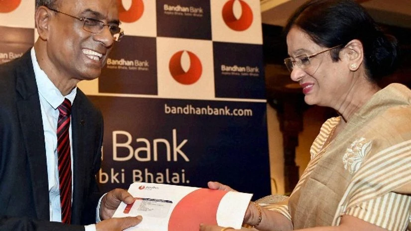 Founder, MD and CEO, Bandhan Bank, Chandra Shekhar Ghosh hands over the first card to a customer during the launch of the bank's International Debit Card and NRI Banking in Kolkata Founder, MD and CEO, Bandhan Bank, Chandra Shekhar Ghosh hands over the first card to a customer during the launch of the bank's International Debit Card and NRI Banking in Kolkata