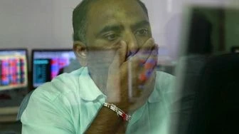 A broker reacts while trading at his computer terminal at a stock brokerage firm in Mumbai (pic: Reuters) A broker reacts while trading at his computer terminal at a stock brokerage firm in Mumbai (pic: Reuters)