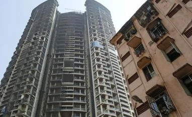 Tata Capital in talks with Oman SGRF for realty fund An under construction high-rise residential tower is pictured behind an old residential building in Mumbai