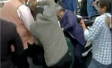 JNU row: Mayhem at Patiala House court; lawyers thrash students, journalists BJP MLA OP Sharma beats up an unidentified man outside Delhi's Patiala House court
