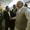 Prime Minister Narendra Modi (L) shakes hand with Mukesh Ambani, chairman of Reliance Industries Limited during a visit to a pavilion at the exhibition centre of the 'Make In India' week in Mumbai
