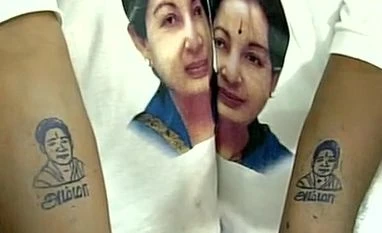 DMK accuses AIADMK of violating poll code AIADMK party workers get Jayalalithaa's picture tattooed on their arms to mark her 68th birthday. Photo: ANI