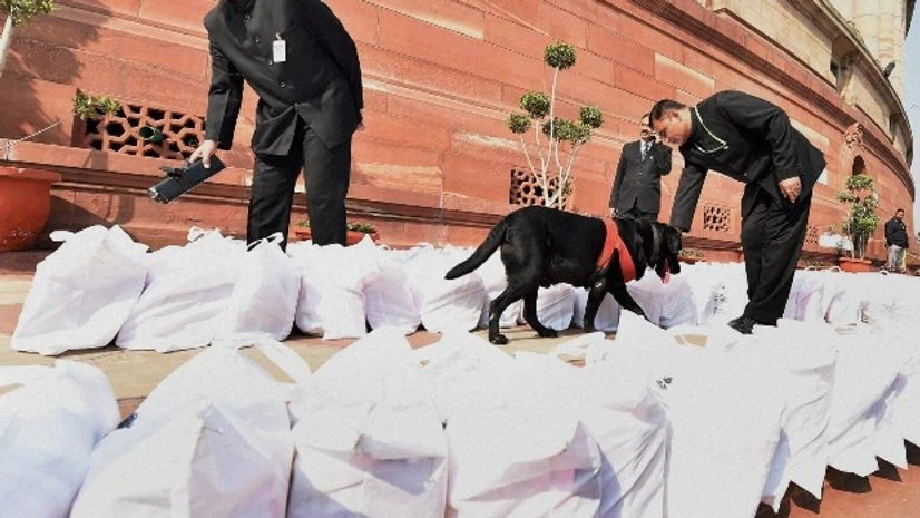 Security persons with a sniffer dog checking Rail Budget documents at Parliament house during the Budget session, in New Delhi Security persons with a sniffer dog checking Rail Budget documents at Parliament house during the Budget session, in New Delhi