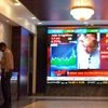 People Bombay Stock Exchange walking past a digital screen showing Arun Jaitley's Budget speech (pic: Kamlesh Pednekar)