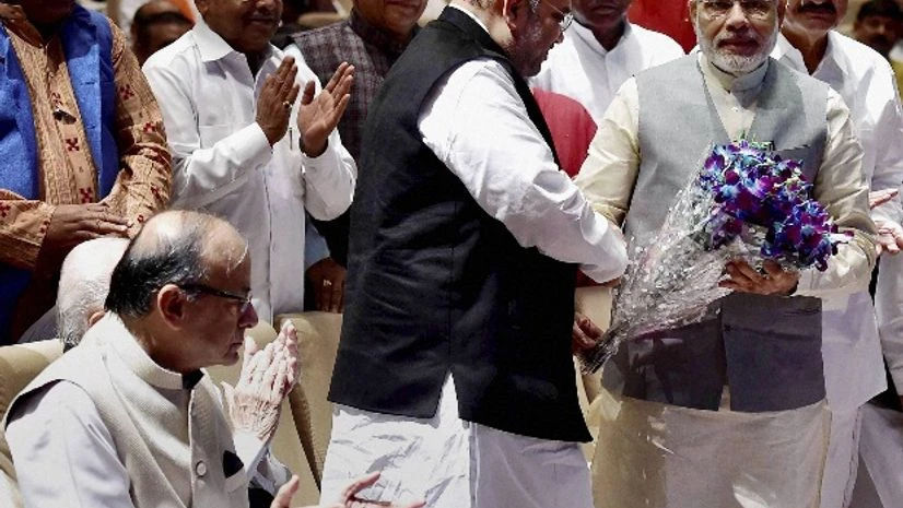 Prime Minister Narendra Modi being greeted by BJP president Amit Shah at a meeting of ruling National Democratic Alliance MP's in New Delhi. lso seen in the picture are Finance Minister Arun Jaitley and other leaders. Prime Minister Narendra Modi being greeted by BJP president Amit Shah at a meeting of ruling National Democratic Alliance MP's in New Delhi. lso seen in the picture are Finance Minister Arun Jaitley and other leaders.