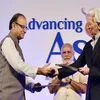 Prime Minister Narendra Modi claps as Union Finance Minister Arun Jaitley and IMF MD Christine Lagarde exchange MoU documents at the MOF-IMF Conference on "Advancing Asia: Investing for the Future", in New Delhi