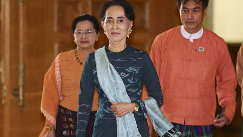 National League for Democracy party (NLD) leader Aung San Suu Kyi, center, arrives in parliament in Naypyitaw, Myanmar, Tuesday, March 15, 2016 (Photo: AP/PTI) National League for Democracy party (NLD) leader Aung San Suu Kyi, center, arrives in parliament in Naypyitaw, Myanmar, Tuesday, March 15, 2016 (Photo: AP/PTI)