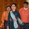 National League for Democracy party leader Aung San Suu Kyi, centre, arrives in Manama's parliament in Naypyitaw, Myanmar