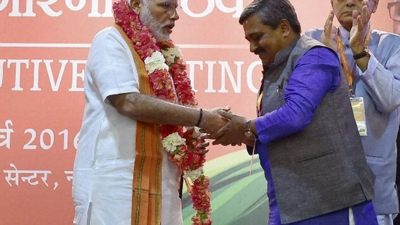 Narendra Modi Prime Minister Narendra Modi being greeted by Delhi BJP president Upadhaya at party's National Executive meet, in New Delhi Photo courtesy: PTI