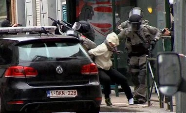 In this framegrab taken from VTM, something appears to drop from inside the trouser leg of Salah Abdeslam, centre, as he is arrested by police and bundled into a police vehicle during a raid in the Molenbeek neighborhood of Brussels, Belgium. In this framegrab taken from VTM, something appears to drop from inside the trouser leg of Salah Abdeslam, centre, as he is arrested by police and bundled into a police vehicle during a raid in the Molenbeek neighborhood of Brussels, Belgium.