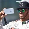 Mercedes driver Lewis Hamilton of Britain takes a selfie at the drivers group photo prior to the start of the Australian Formula One Grand Prix at Albert Park in Melbourne, Australia