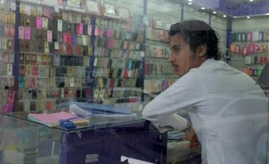 Soft June quarter likely for telecom sector A Yemeni vendor looks out as he waits for customers in a mobile shop at a mall in Dammam, Saudi Arabia