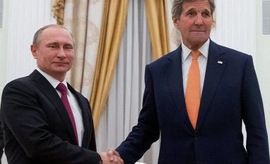 US expels two Russian officials after its diplomat attacked US Secretary of State John Kerry shakes hands with Russian President Vladimir Putin (File Photo)