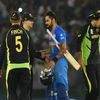 Indian batsman Virat Kohli greeted by Australian players after winning the ICC World T20 match against Australia at PCA cricket stadium in Mohali