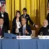 Seated from left, Chinese President Xi Jinping, President Barack Obama, and India's Prime Minister Narendra Modi, gather for a working dinner with heads of delegations of the Nuclear Security Summit in the East Room of the White House in Washington