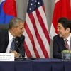 President Barack Obama speaks with Japanese Prime Minister Shinzo Abe during their meeting with South Korean President Park Geun-hye at the Nuclear Security Summit   PTI
