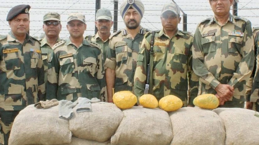 BSF, Officers, Security personnel BSF officials pose with four kgs of heroin recovered near an Indo-Pak border outpost at Uddhar Dhariwal in Amritsar PTI