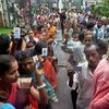 Silchar: Voters stand in queue at a polling booth to caste their vote during the first phase of the Assam assembly polls in Silchar on Monday. PTI Photo