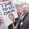 Demonstrators hold placards during a protest London, on Saturday, calling for cameron's resignation