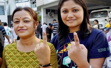 Exit Polls: BJP set to take power in Assam Voters showing their inked finger marks after casting vote in a polling station during the second and final phase of Assam State Assembly election 2016 in Guwahati