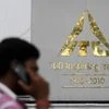 A man talks on his mobile phone as he walks past an ITC office building in Kolkata