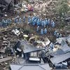 Rescue workers conduct a search and rescue operation at a house that collapsed during a landslide triggered by earthquakes in southern Japan: Reuters