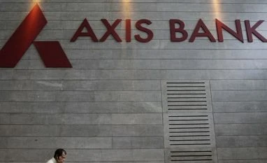 Axis Bank Q4 net dips after 46 quarters An employee speaks on his mobile phone as he walks inside Axis Bank's corporate headquarters in Mumbai