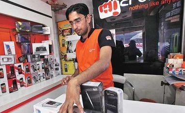 Micromax forays into white goods A worker displays Micromax mobile phones inside a store in Kolkata