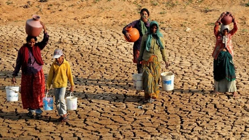 drought, drinking water Women return after collecting water from a lake in drought-hit Dambadahalli near Chikmagalur in Karnataka