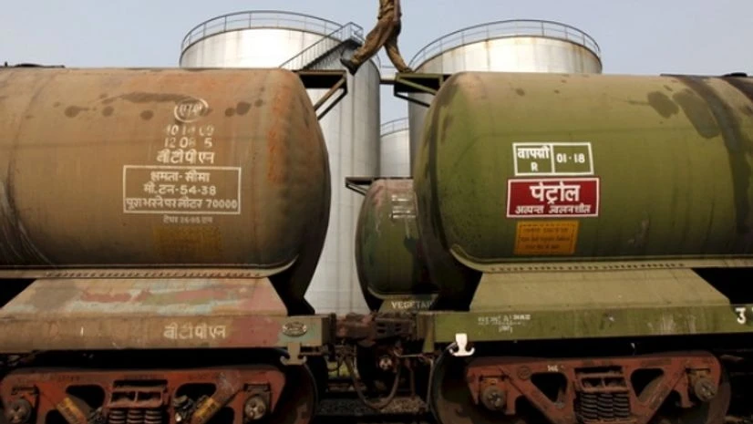 oil, crude, A worker walks atop a tanker wagon to check the freight level at an oil terminal on the outskirts of Kolkata