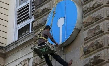 SBI surges 9% on stable asset quality An electrician puts lights on the logo of State Bank of India at its main branch in Mumbai