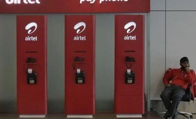 Bharti Airtel to sell 950 towers in Congo An employee sits at a Bharti Airtel public phone booth installed at the airport in New Delhi