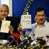 Delhi Chief Minister Arvind Kejriwal with Dy CM Manish Sisodia showing Congress and BJP party manifestos at a press conference at Delhi Secretariat on Wednesday.  BJP and Congress in their manifestos have also promised for full statehood to the Delhi