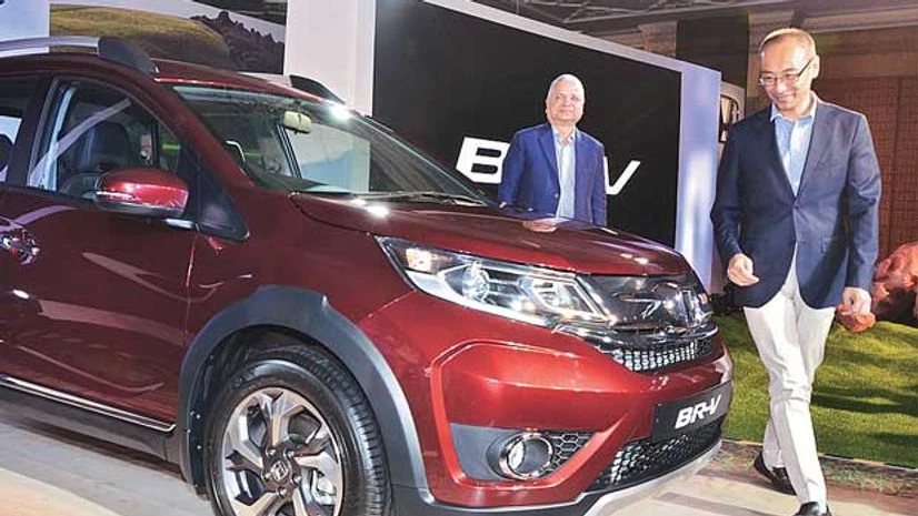 Honda Cars India CEO Yoichiro Ueno (in front) at the launch of the BR-V (diesel) in Mumbai Honda Cars India CEO Yoichiro Ueno (in front) at the launch of the BR-V (diesel) in Mumbai