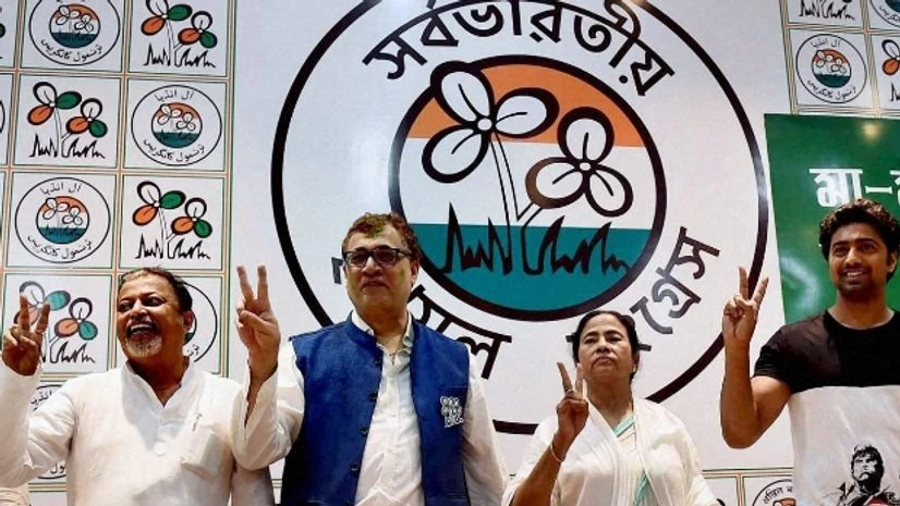 TMC, Mamata Banerjee, Trinamool West Bengal CM Mamata Banerjee flashes victory sign with party leaders after the party's thumping win in West Bengal Assembly elections