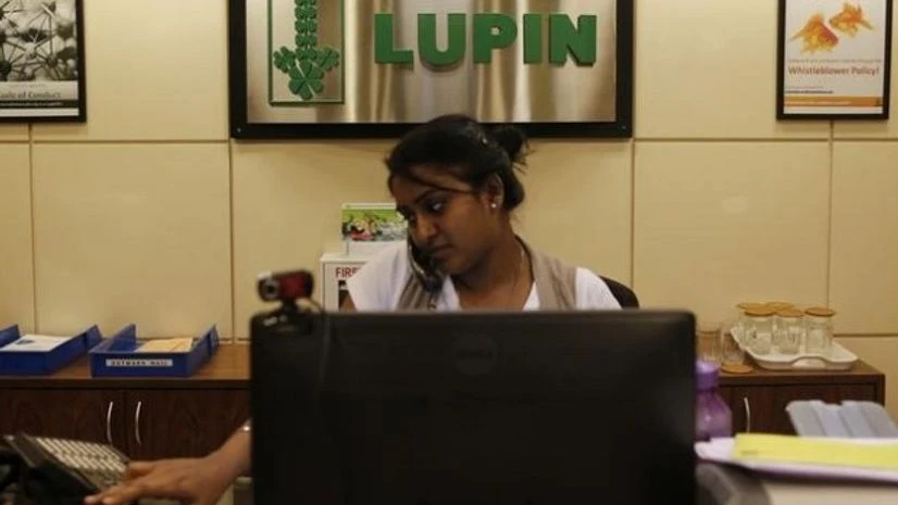 An employee of Lupin Limited works at a reception at their headquarters in Mumbai An employee of Lupin Limited works at a reception at their headquarters in Mumbai