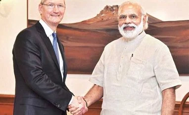Cook, Modi meet but Apple yet to commit on Make in India Apple CEO Tim Cook (left) with Prime Minister Narendra Modi in New Delhi on Saturday. Cook also launched an updated version of the 'Narendra Modi Mobile App'
