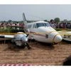 People looking at the air ambulance which crash landed at Kair village in Najafgarh area of Delhi