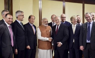 Switzerland backs India's bid for NSG membership Prime Minister Narendra Modi and Switzerland's President Johann Schneider-Ammann, pose with business men at a meeting in Geneva, Switzerland