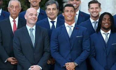 FIFA president Gianni Infantino, center left, stands next to team captain Cristiano Ronaldo, center right, while posing for a photo with Portuguese President Marcelo Rebelo de Sousa, second left, and the Portuguese soccer team at the Belem presidenti FIFA president Gianni Infantino, center left, stands next to team captain Cristiano Ronaldo, center right, while posing for a photo with Portuguese President Marcelo Rebelo de Sousa, second left, and the Portuguese soccer team at the Belem presidenti