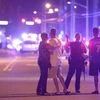 Orlando Police officers direct family members away from a multiple shooting at a nightclub in Orlando, Florida. Photo: AP/PTI
