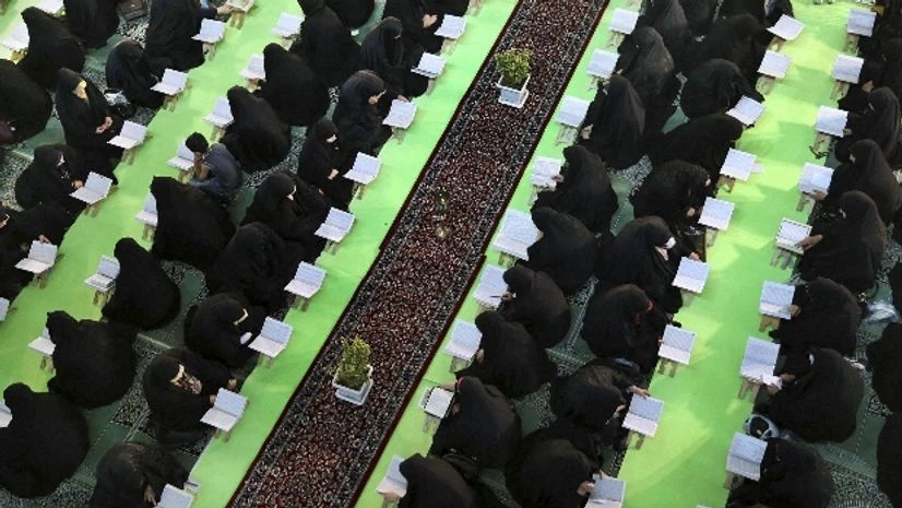 Representational image Iranian women recite verses of the Quran, Islam's holy book, in a mosque at the shrine of Shiite Saint Abdulazim during Muslim holy fasting month of Ramadan in Shahr-e-Ray, south of Tehran, Iran