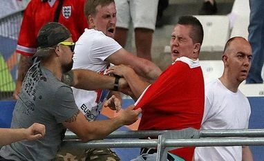 UEFA gives Russia 'suspended disqualification' from Euro 2016 Russian supporters attack an England fan at the end of the Euro 2016 Group B soccer match between England and Russia at the Velodrome stadium in Marseille, France