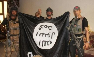 At least 13 Islamic State militants killed in airstrikes by Iraq jets Iraqi soldiers pose with an Islamic State militant flag in Fallujah, Iraq. File Photo