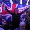 A Brexit supporter holds a Union Flag at a Vote Leave rally in London
