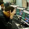 hare brokers react to falling stock prices on screens of computers and television